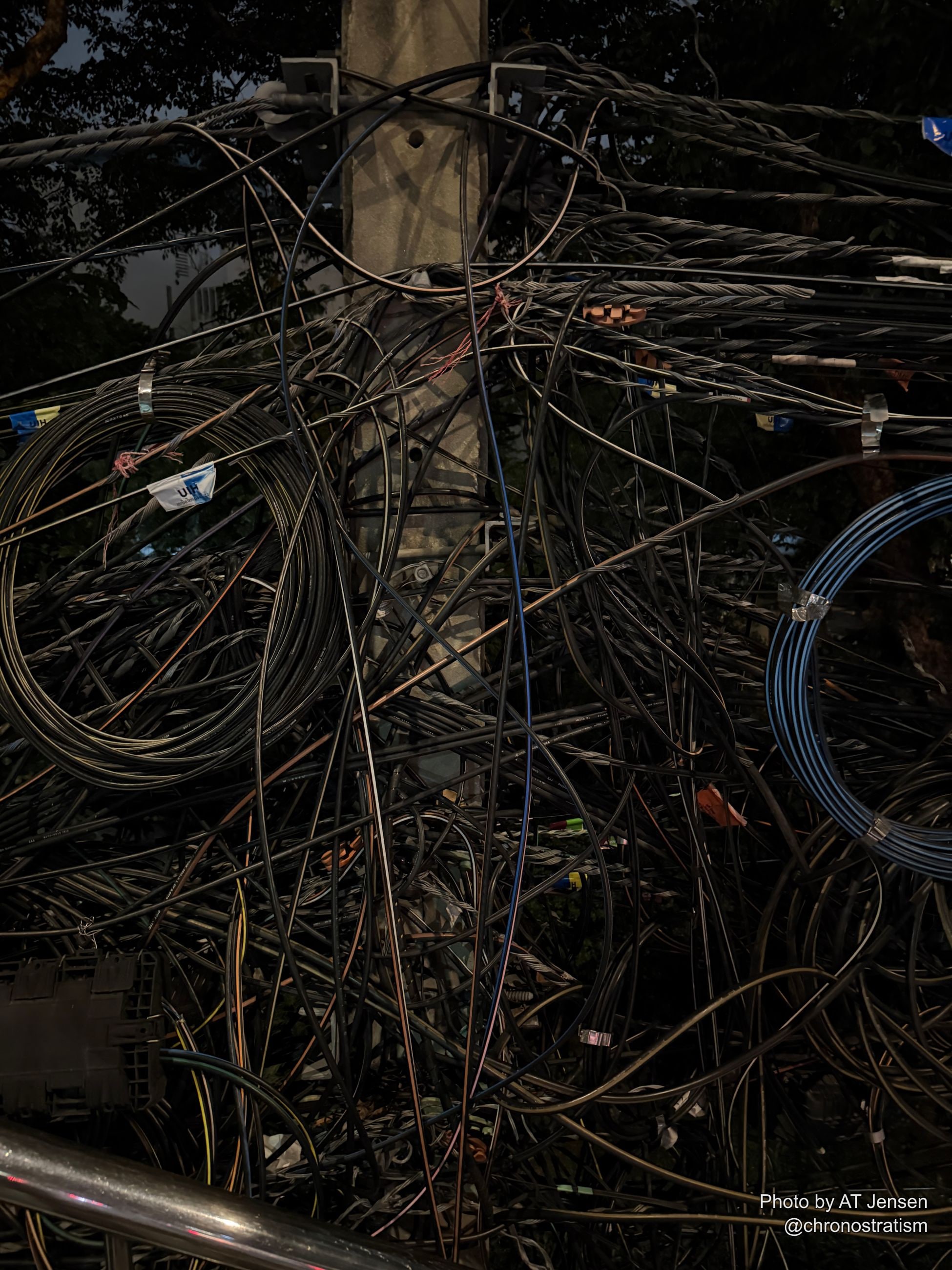 A dense tangle of black utility cables spills around a stencilled junction box marked SSD-SM.