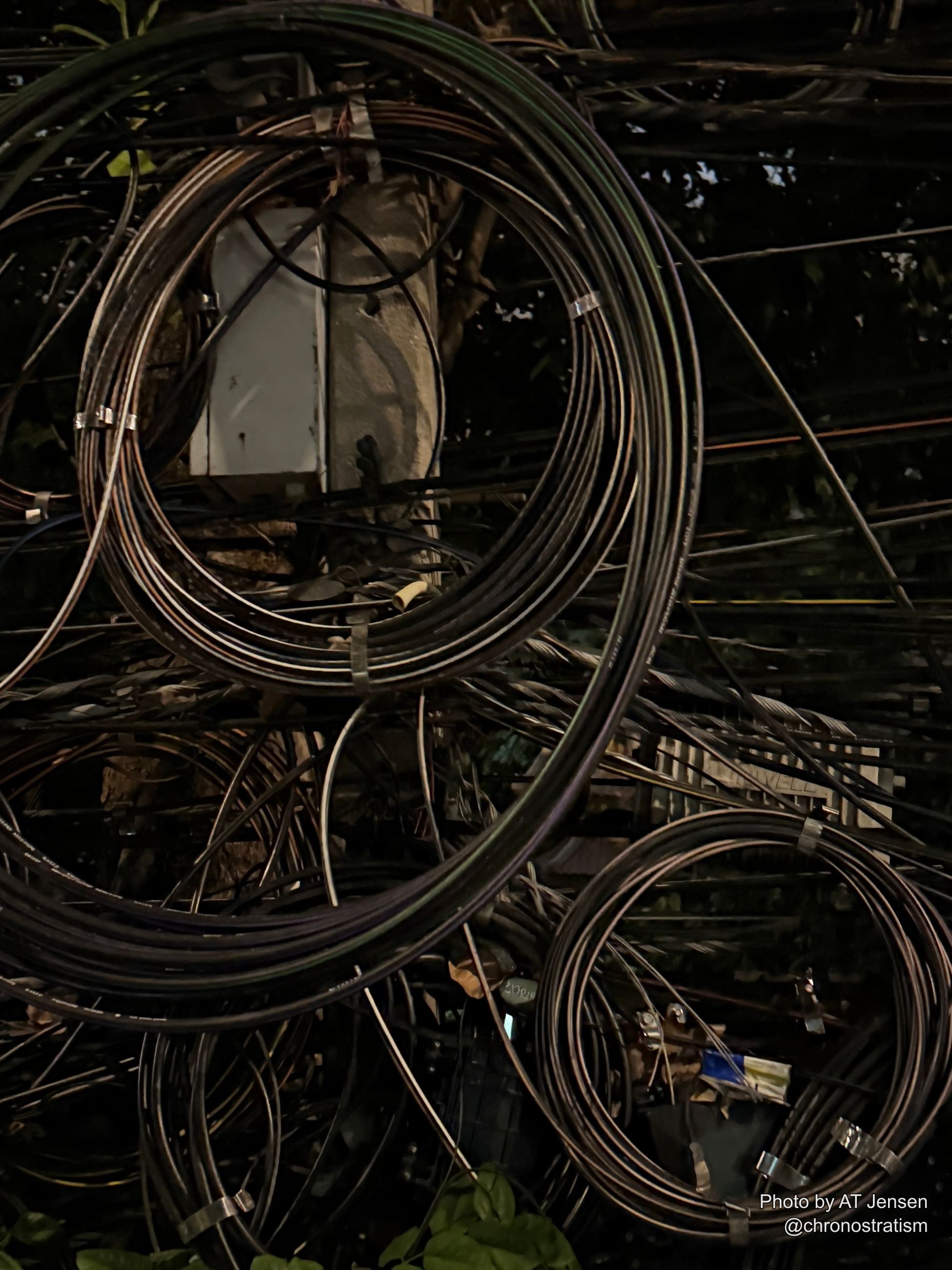 A final tangle of night wiring frames the stencilled junction box from below.