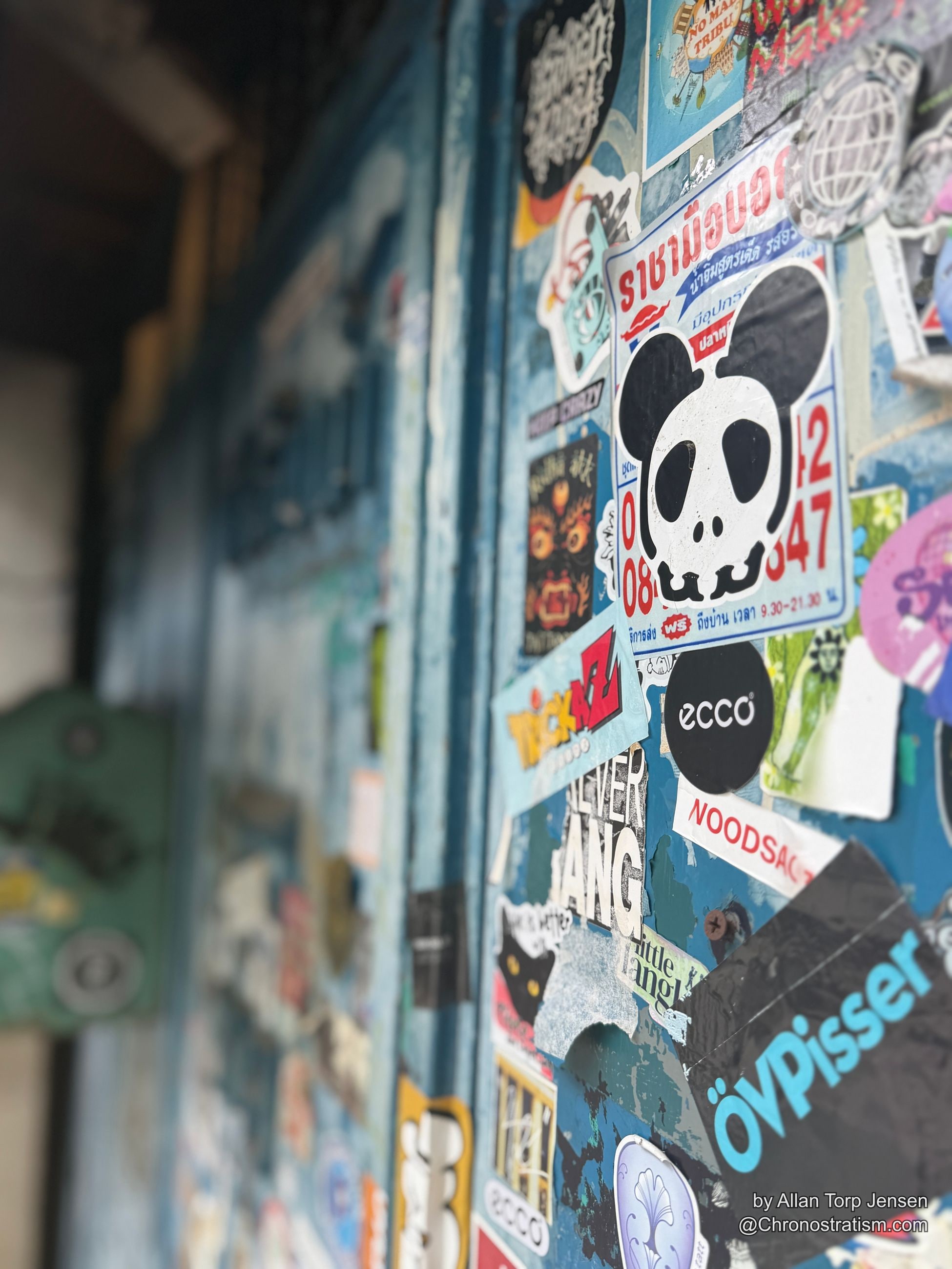 Macro detail of character and crew stickers layered directly over one another.