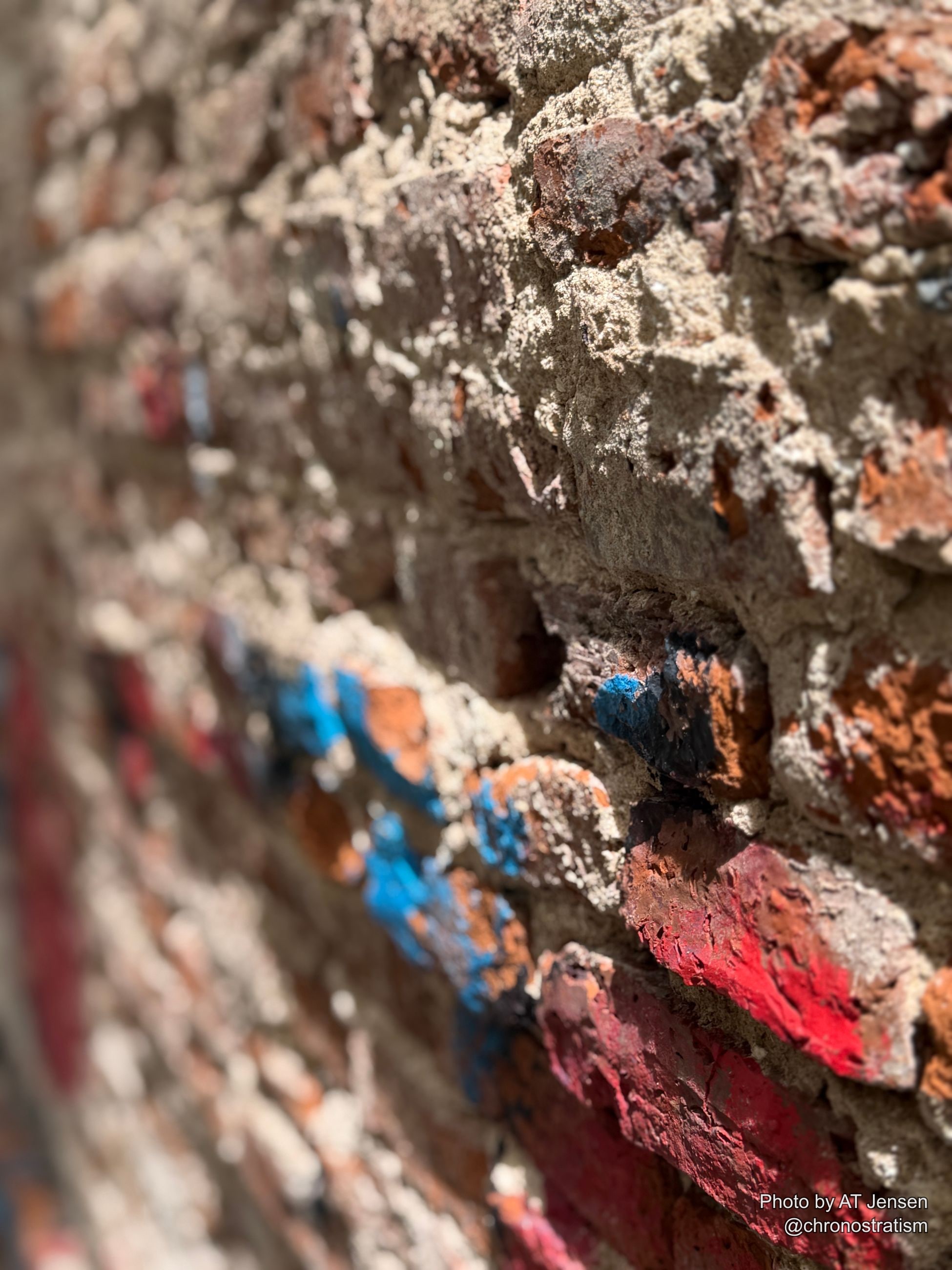 The painted figure continues across a second crumbling plaster panel.