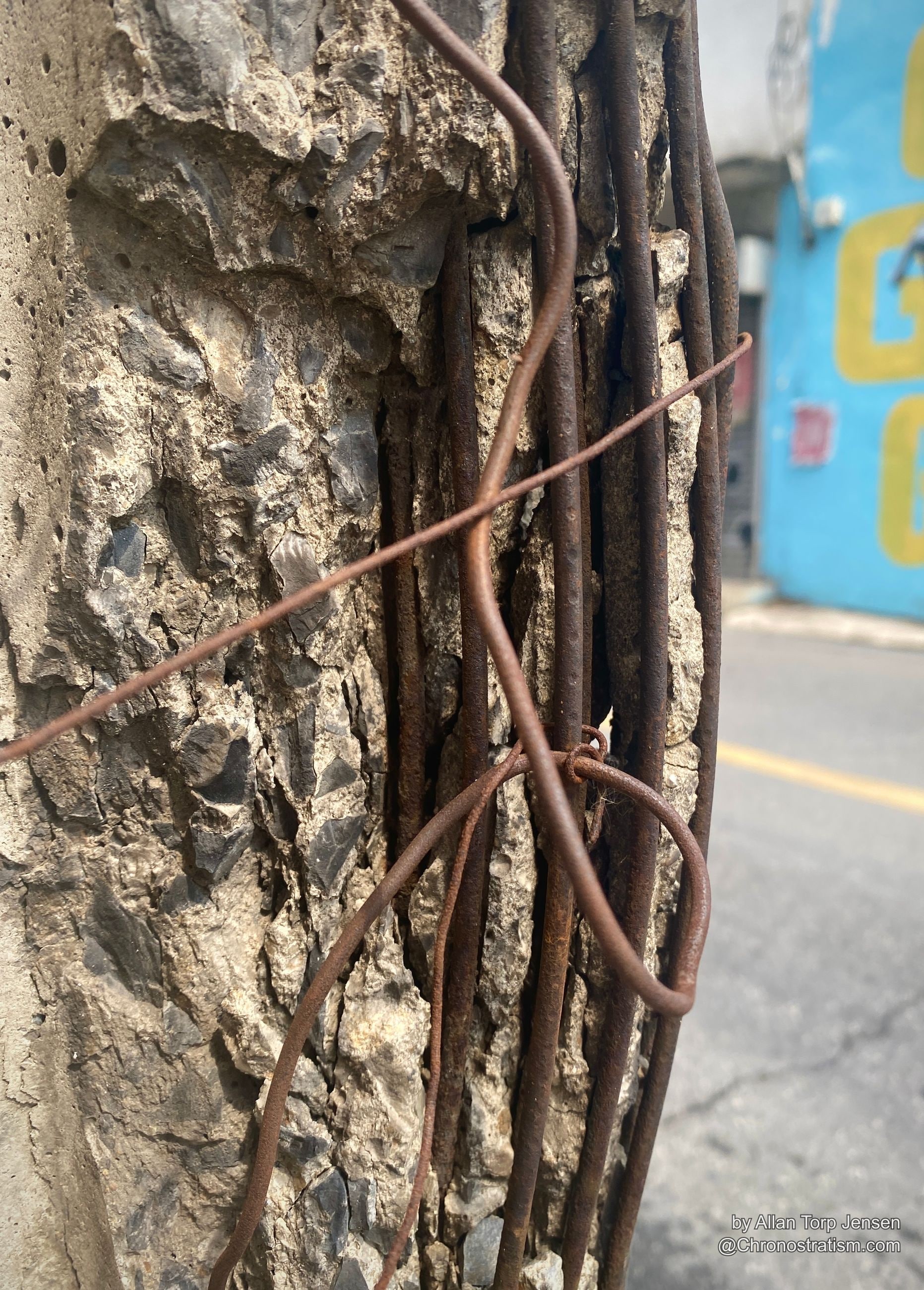 Tangled rust-orange tie wire looping around exposed rebar rods.
